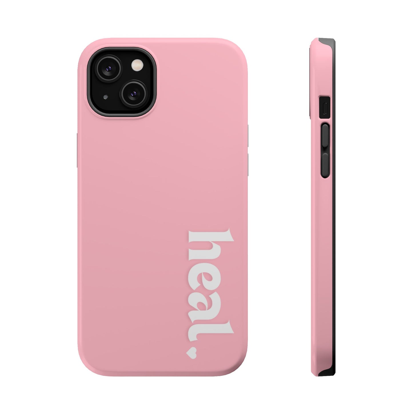 A pink iPhone case with the word 'heal' written on it, displayed on a table with candles and flowers in the background.