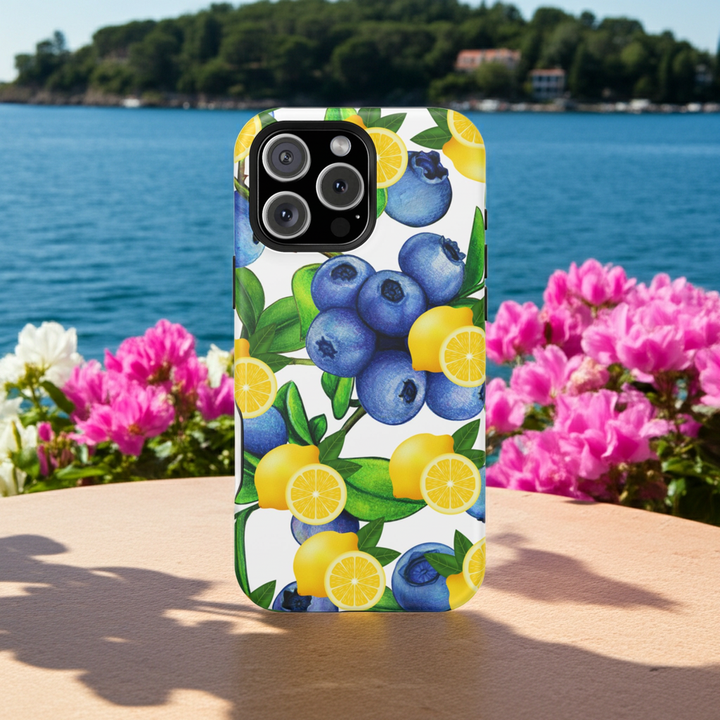 iPhone case with blueberries and lemons design on a table with flowers and water background by Mllionaire women online store.