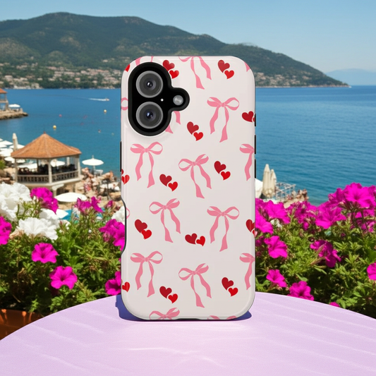 iPhone case with bow and heart pattern on a scenic background