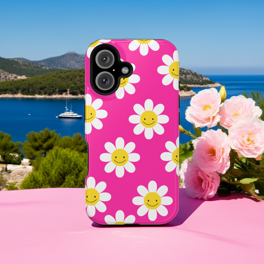 iPhone case with smiley flower design on a pink surface with a scenic background designed to support powerful women on their wealth building journey